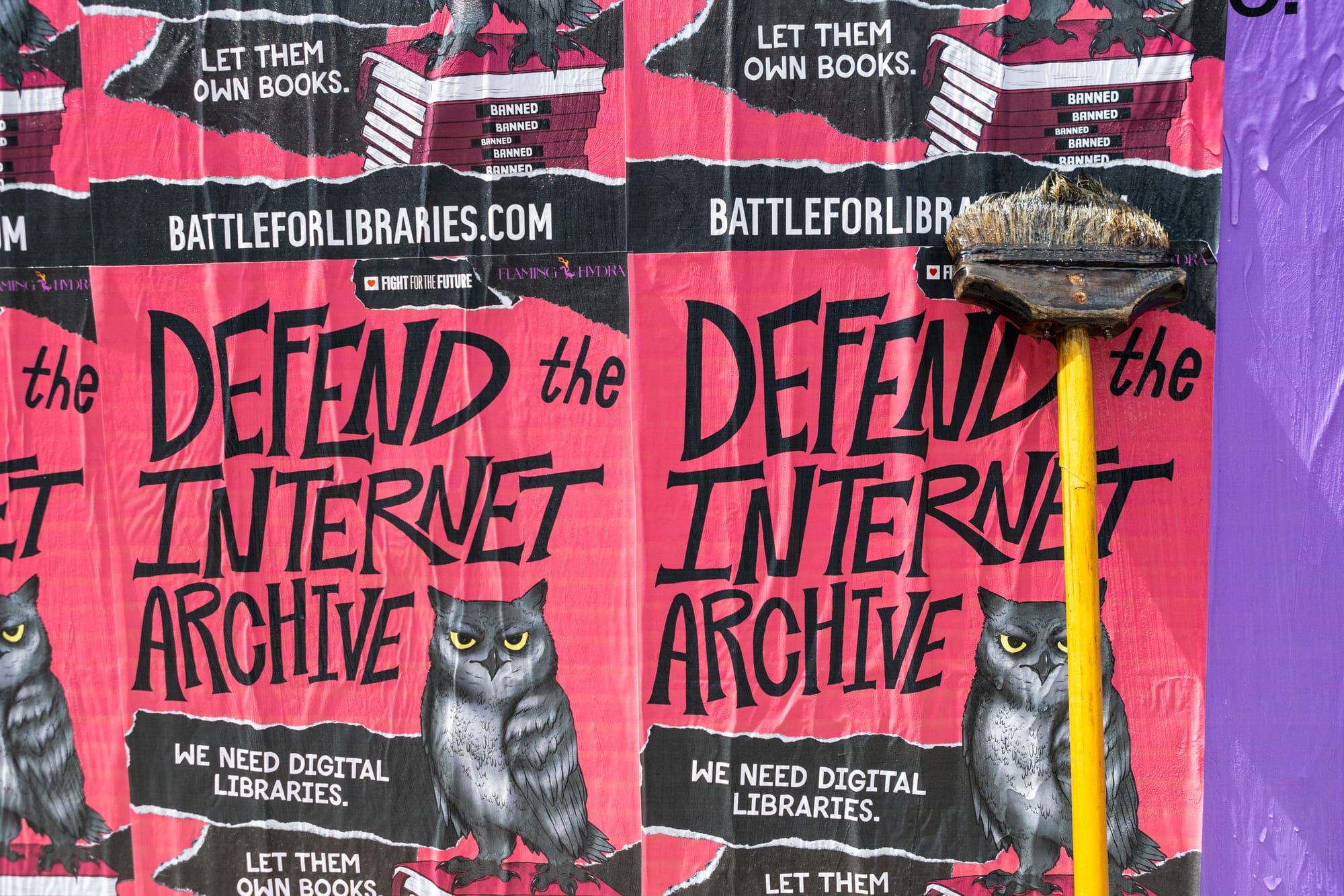 Wheatpaste posters with an owl that say: “Defend the Internet Archive. We need digital libraries. Let them own books. BattleForLibraries.com”