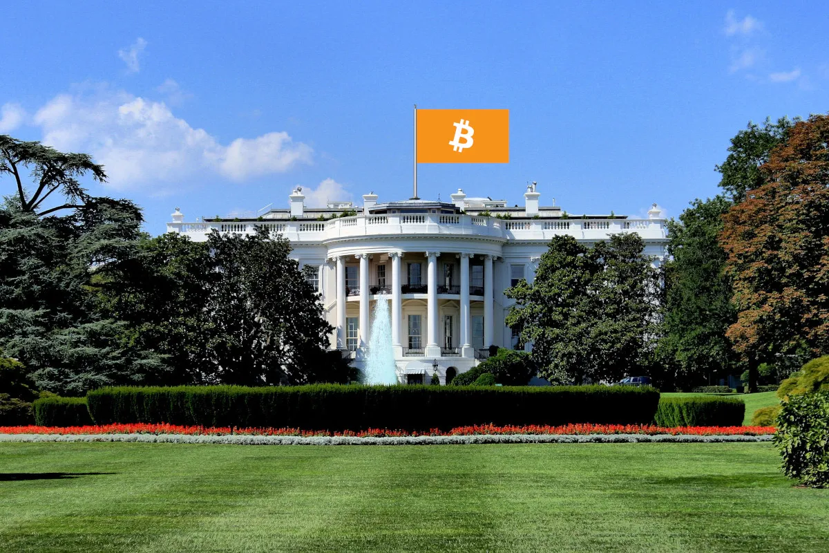 A photograph of the White House, photoshopped with a Bitcoin flag flying above it