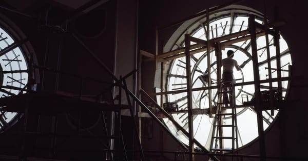 A person repairing the clock inside the clock tower at the Old Post Office in Washington, D.C.